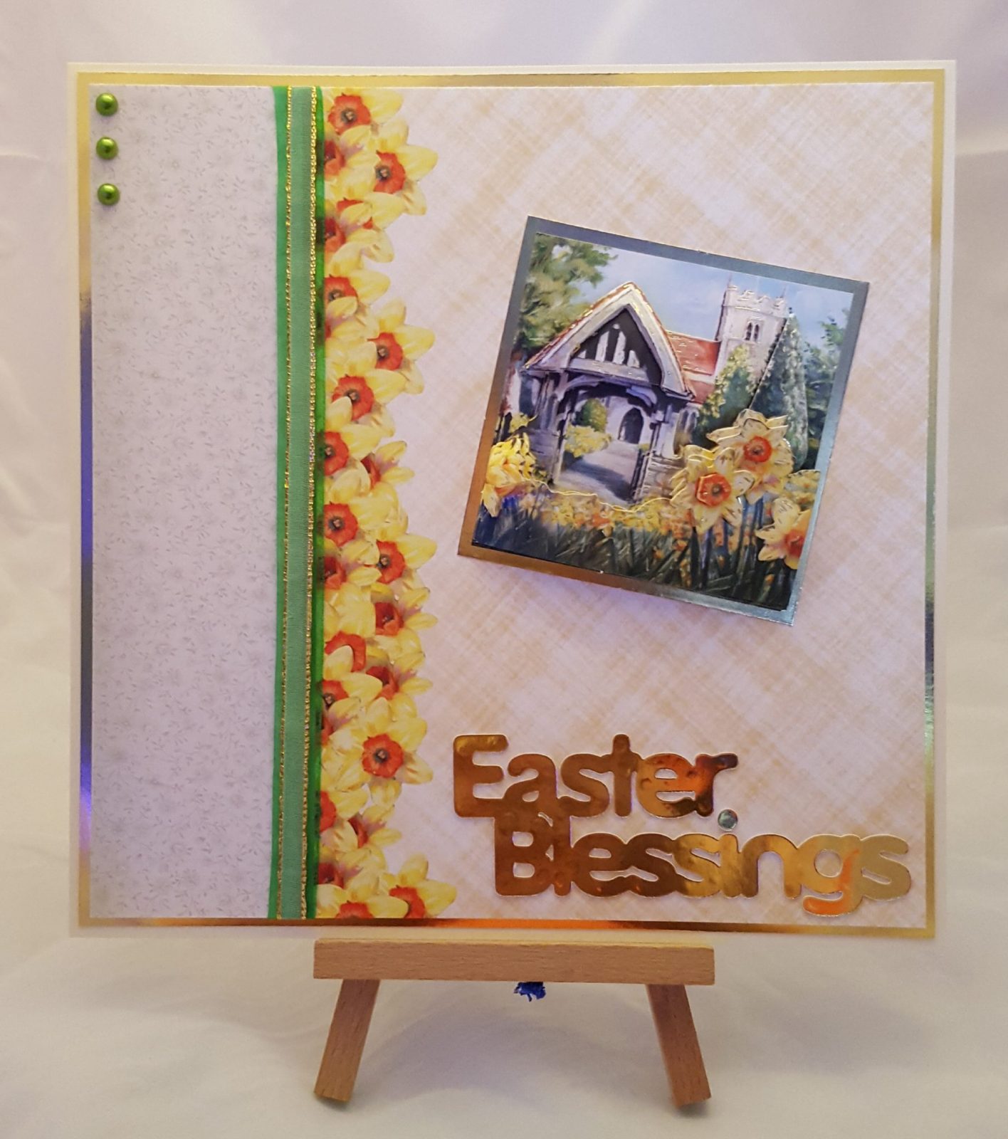 Easter Blessings Card Living Creatively with Fibro | Easter Blessings Card featuring a 3D image of a church and church gate surrounded by Daffodils stating Easter Blessings in Gold Lettering