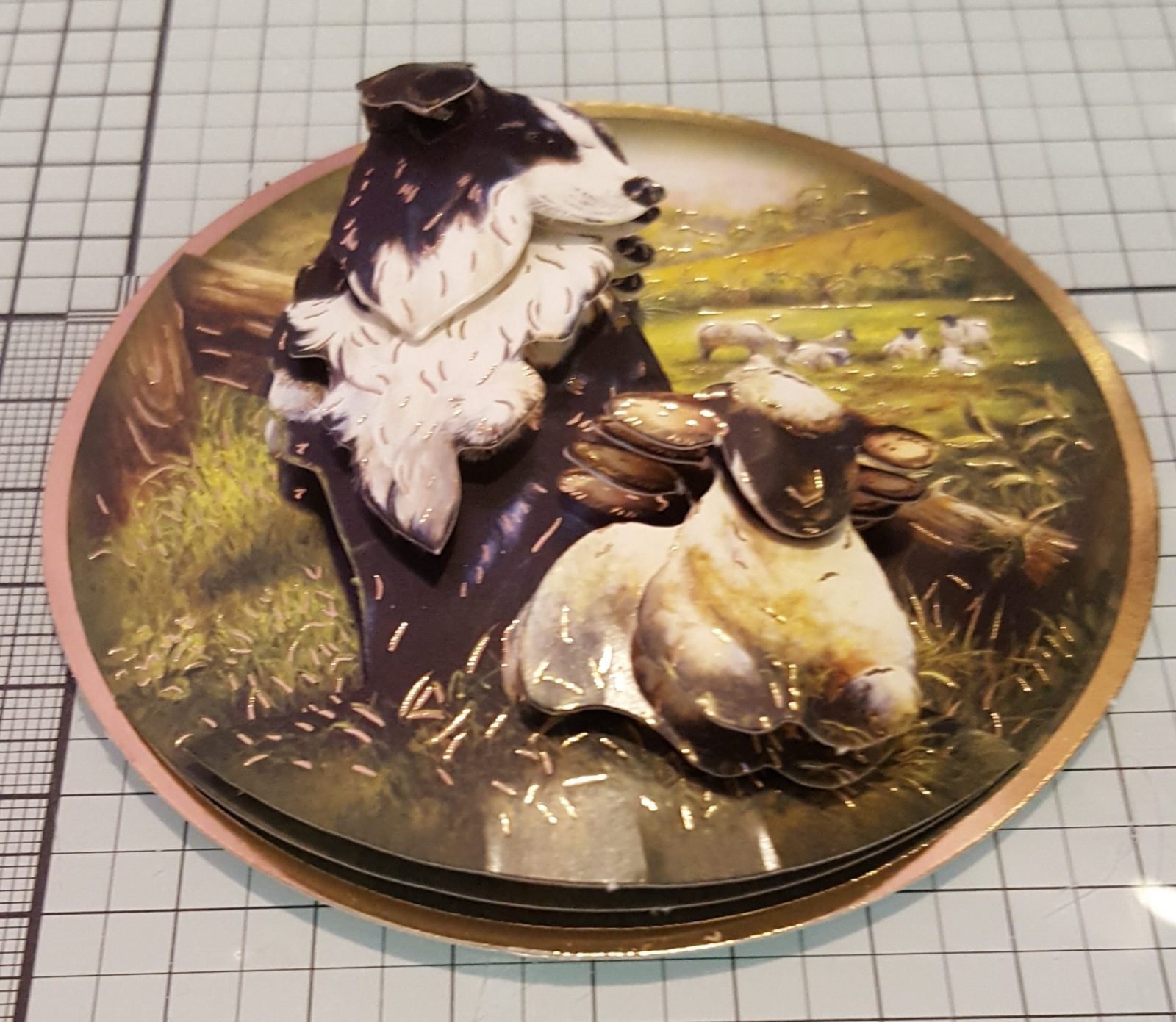 Keeping Watch Decoupage Element Living Creatively with Fibro | A Circular Image featuring a Sheepdog and Lamb in the foreground with a field of lambs behind
