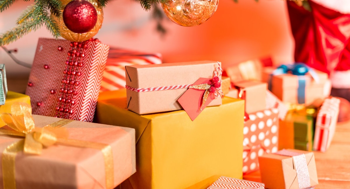 Christmas Gift Ideas for spoonies image of presents under a Christmas Tree
