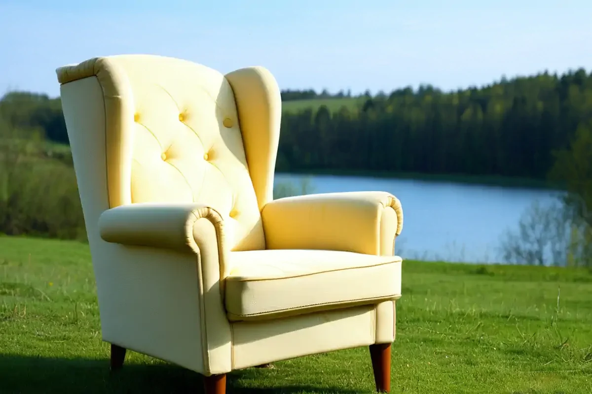 An image of an armchair sat in the countryside, spoonie life is juggling enjoyment with comfort.